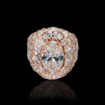 May include: A rose gold ring featuring a large oval-cut diamond as the centerpiece. The ring is surrounded by a halo of smaller diamonds, with additional diamonds set along the band, creating a cluster effect. The diamonds sparkle against a black background.