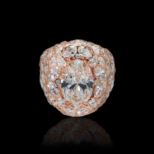 May include: A rose gold ring featuring a large oval-cut diamond as the centerpiece. The ring is surrounded by a halo of smaller diamonds, with additional diamonds set along the band, creating a cluster effect. The diamonds sparkle against a black background.