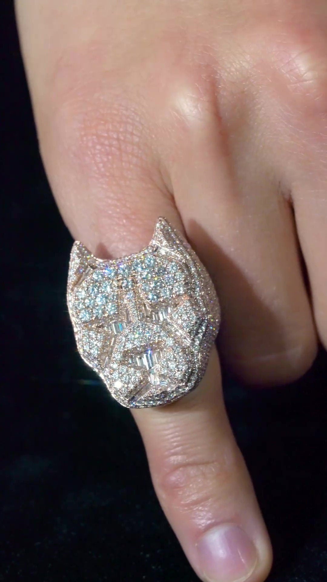 May include: A diamond encrusted ring with a dog head design. The ring is made of gold and has a large, detailed dog head with a diamond studded nose and eyes.