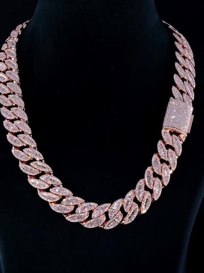 May include: A rose gold chain necklace with baguette-cut diamonds. The chain is a Cuban link style and is very thick.