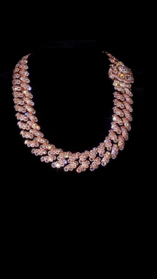 May include: A rose gold necklace with numerous sparkling, clear gemstones. The necklace is set against a black background, highlighting the intricate design and the brilliance of the stones. The necklace is a statement piece.